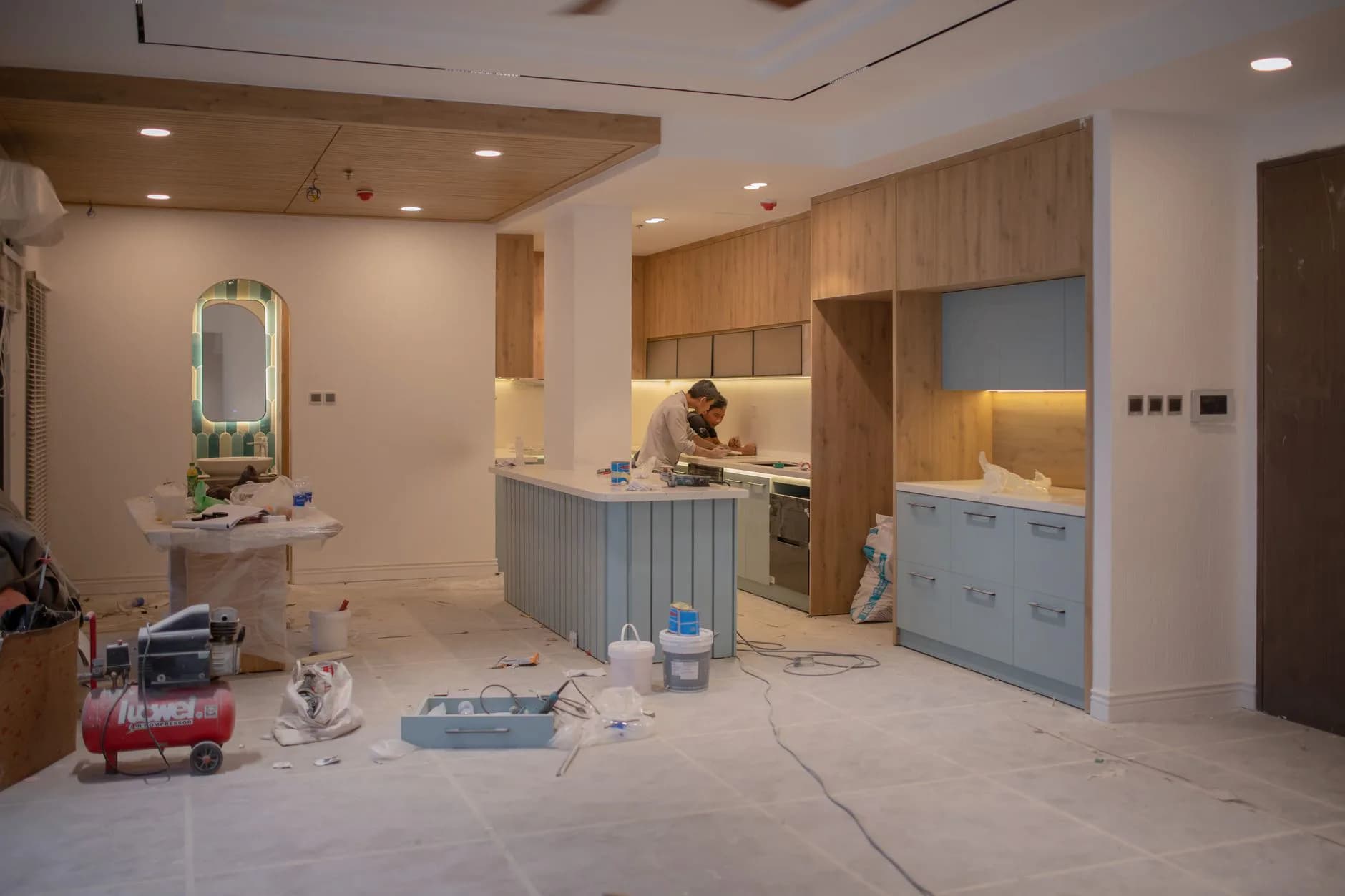 A kitchen mid-renovation with new cabinets being set against the wall