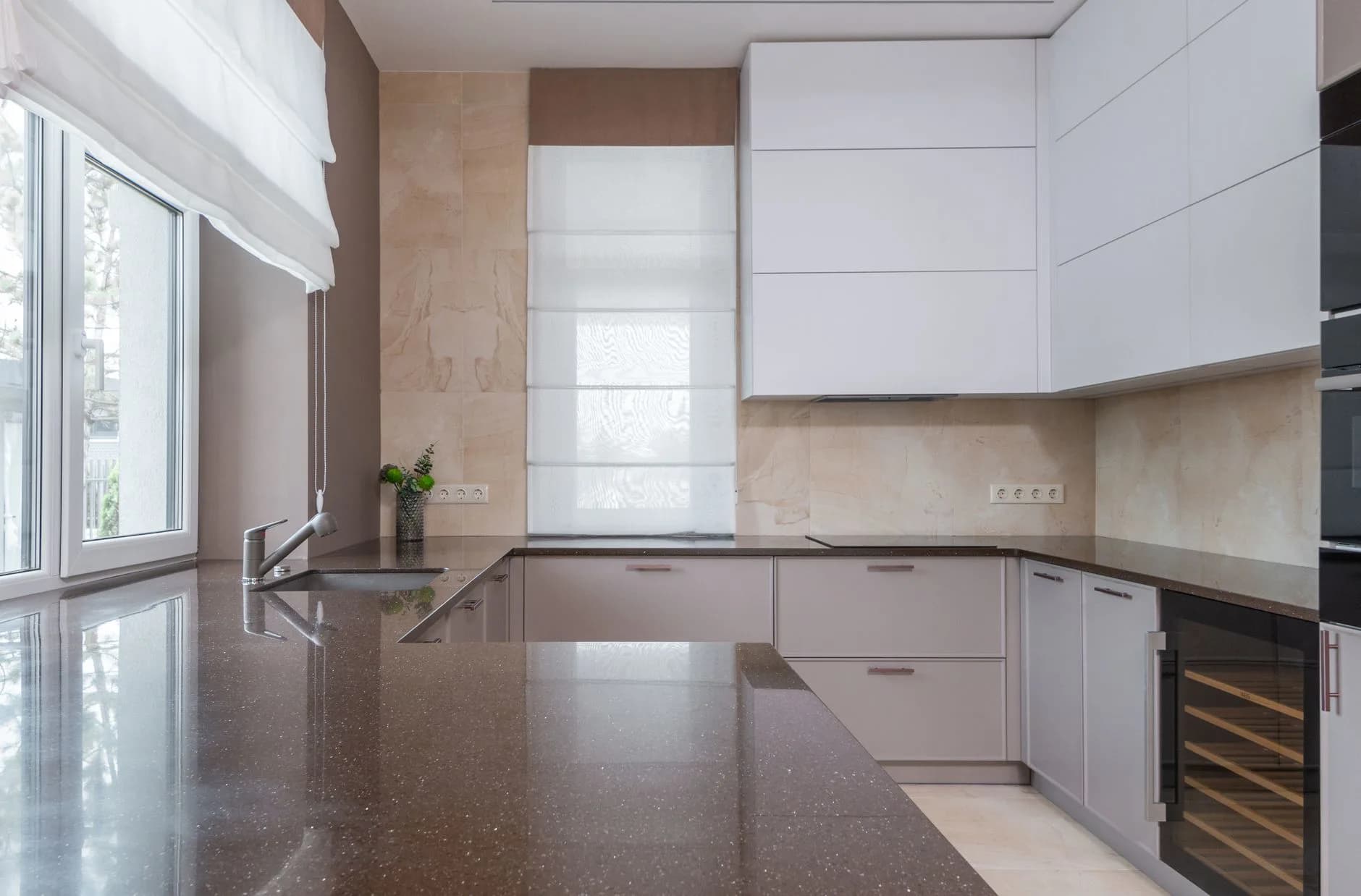 An engineered stone countertop set on kitchen base cabinets