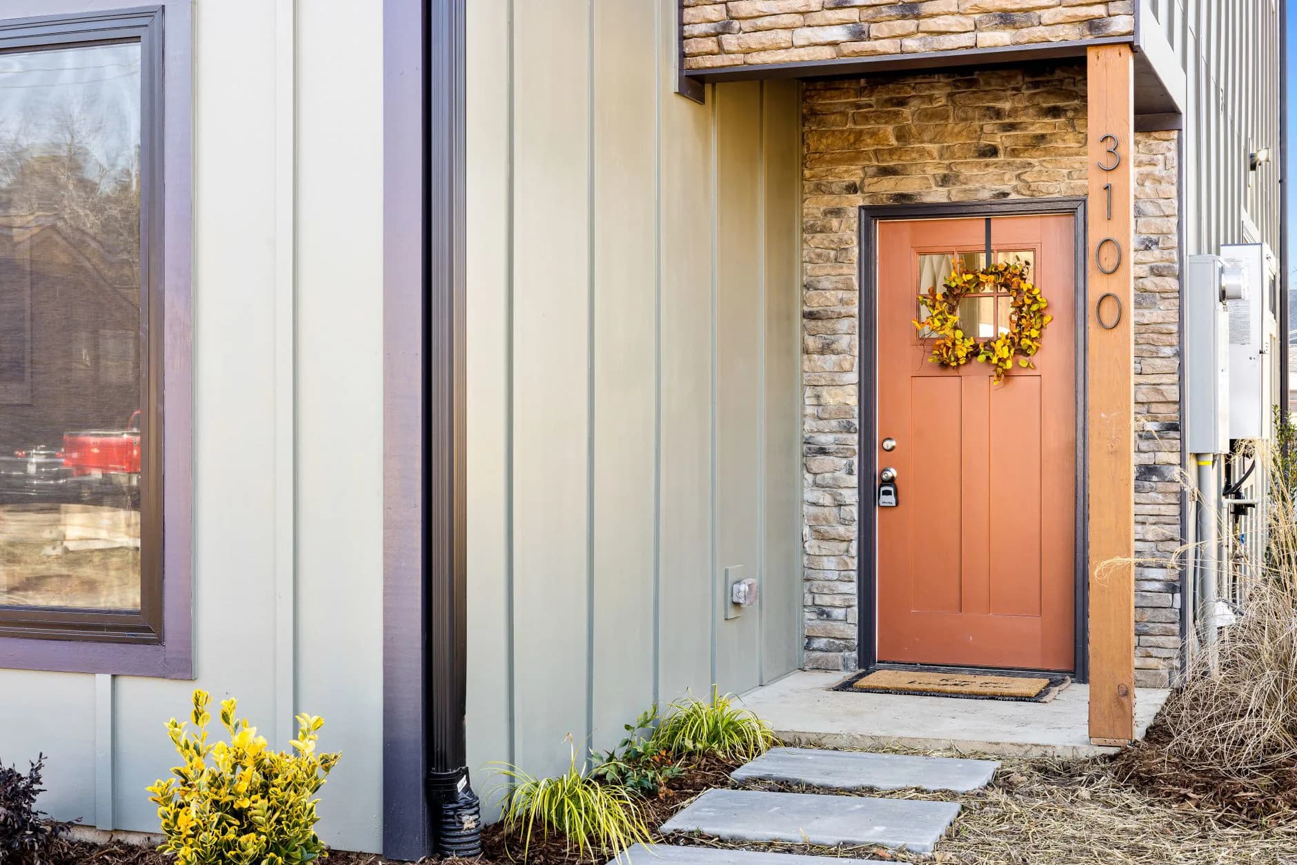 A front entry door set in its frame, with trim and threshold in place