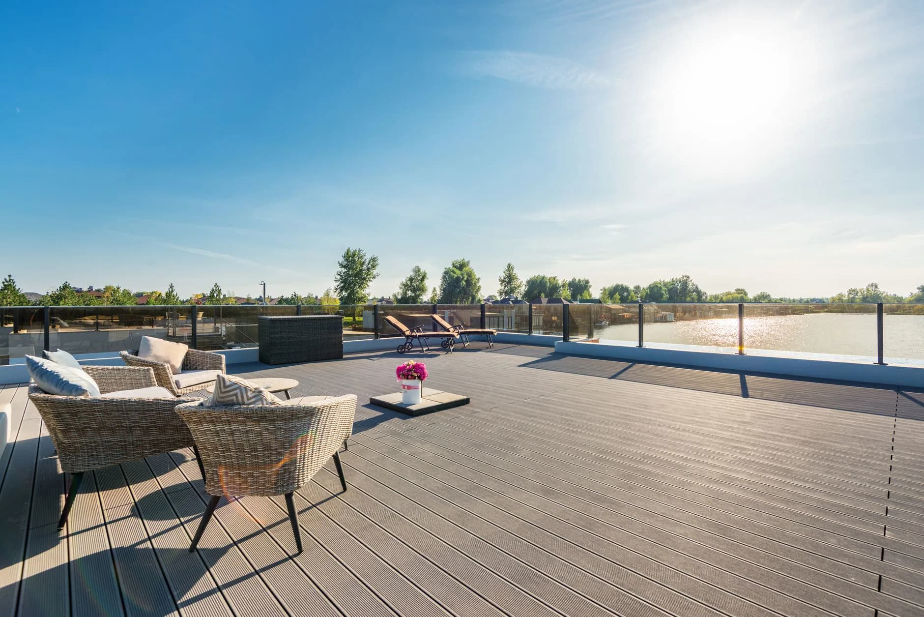 A finished composite deck with railing, seen across the boards