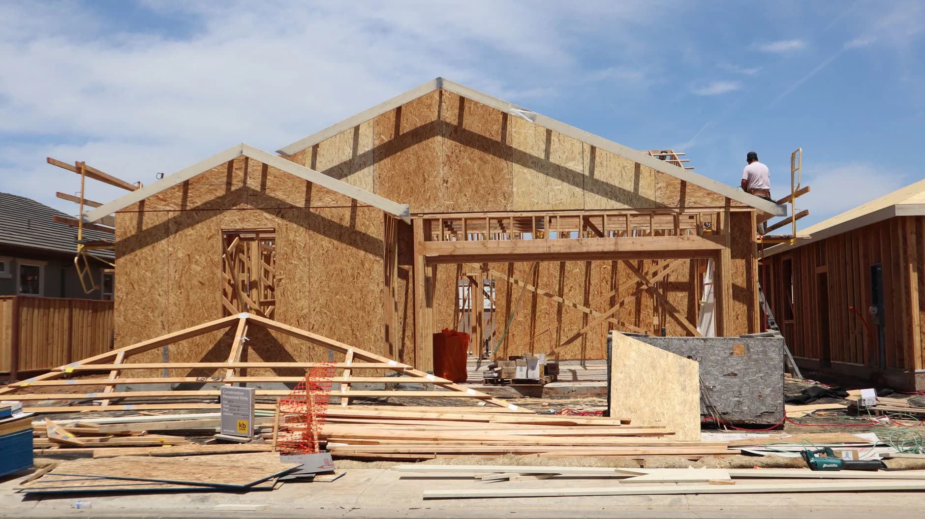 A house at the framing stage, the roof structure still open