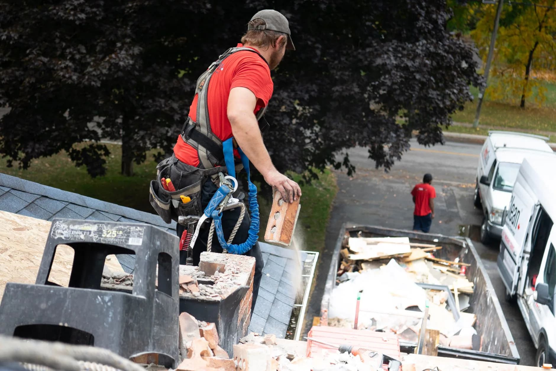 A roofer working in safety harness