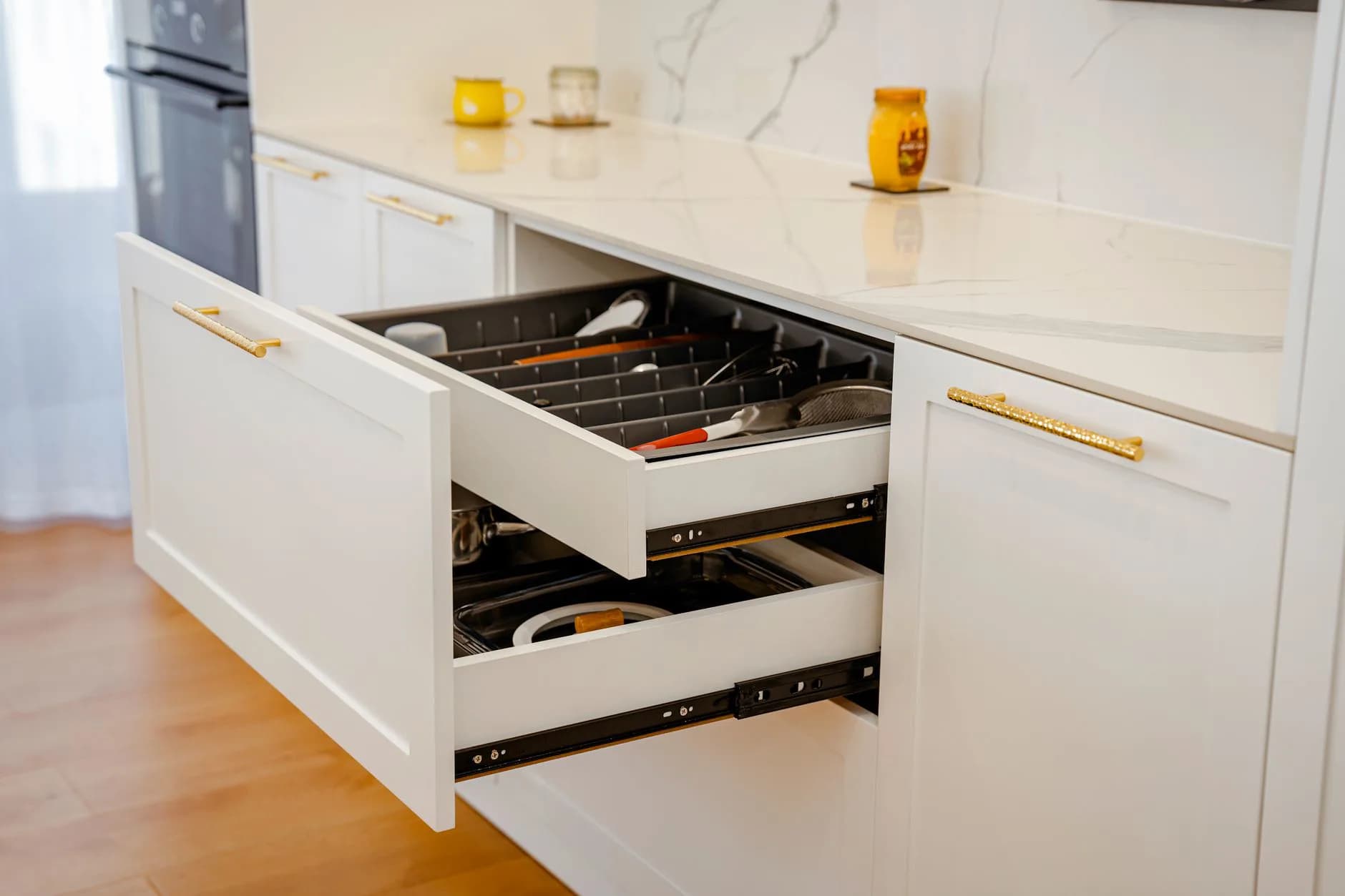 An open kitchen drawer showing its runners