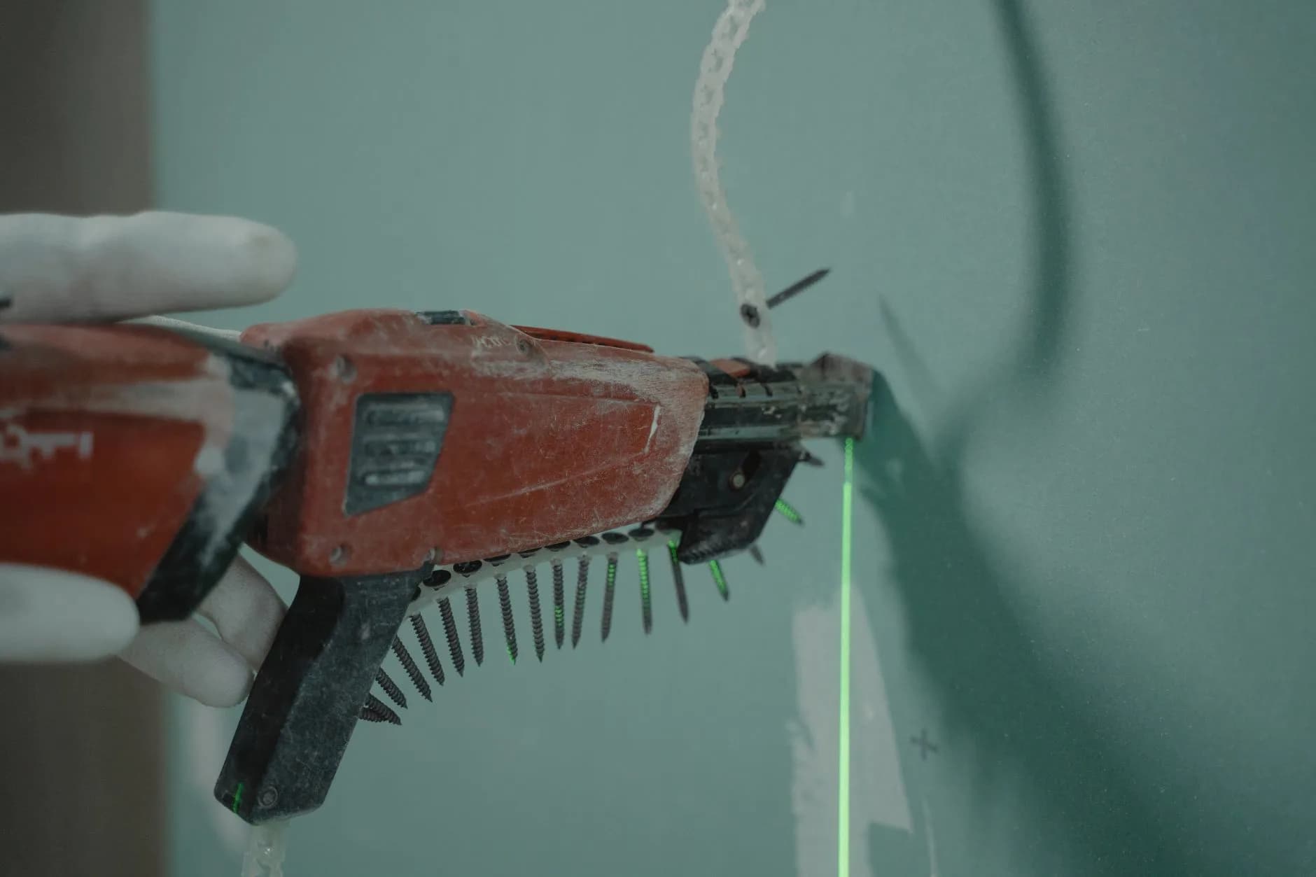 A power tool being used to fasten cladding