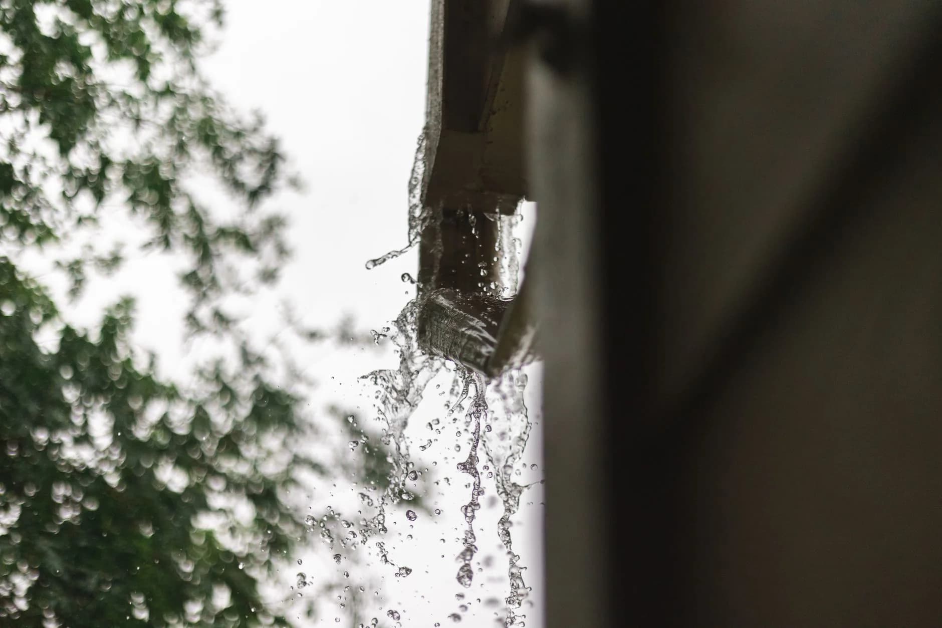 Rainwater pouring from a gutter