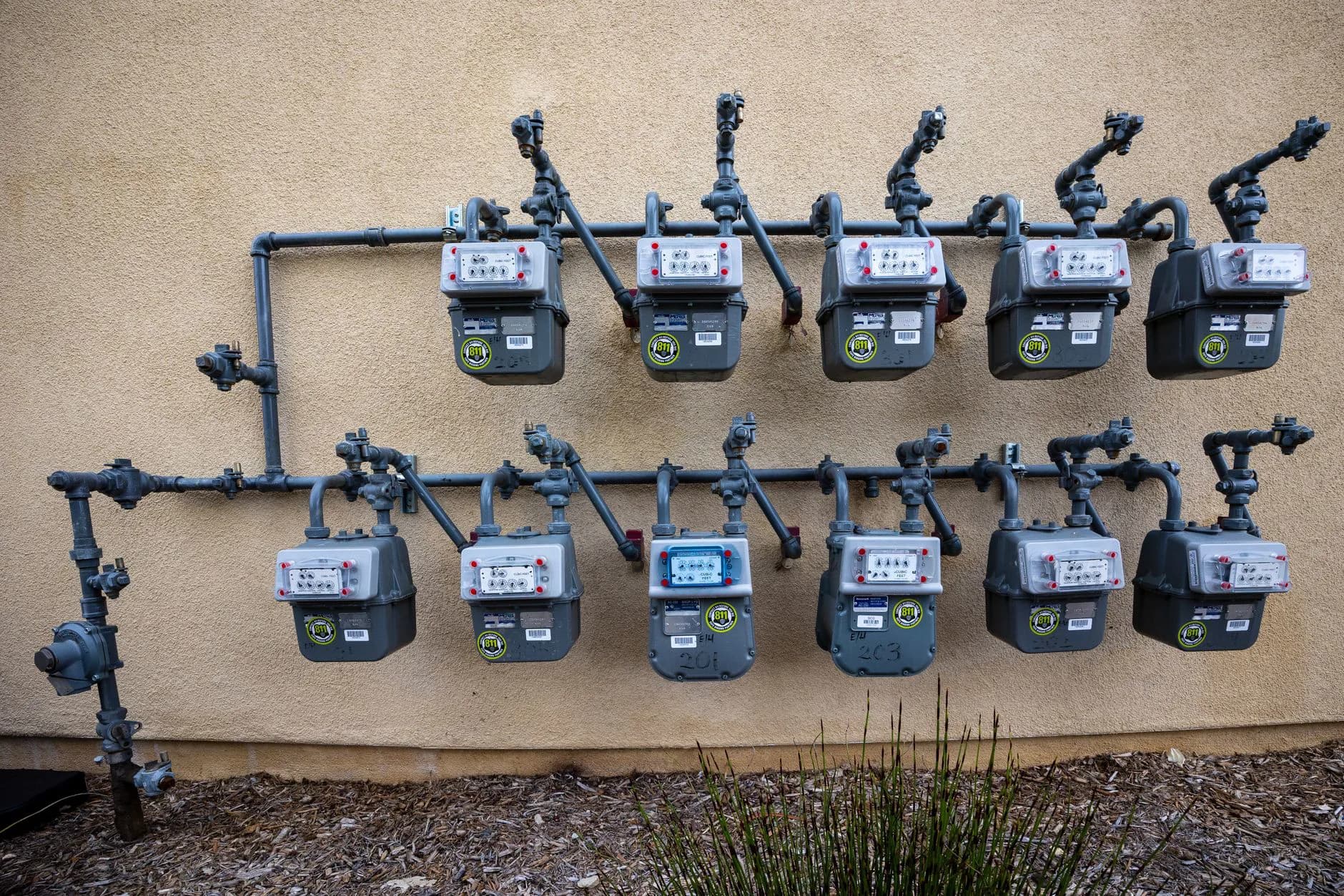 A gas meter and pipework on a wall