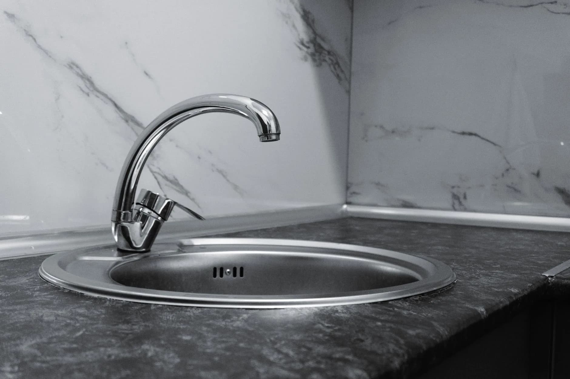 A stainless steel kitchen sink and faucet