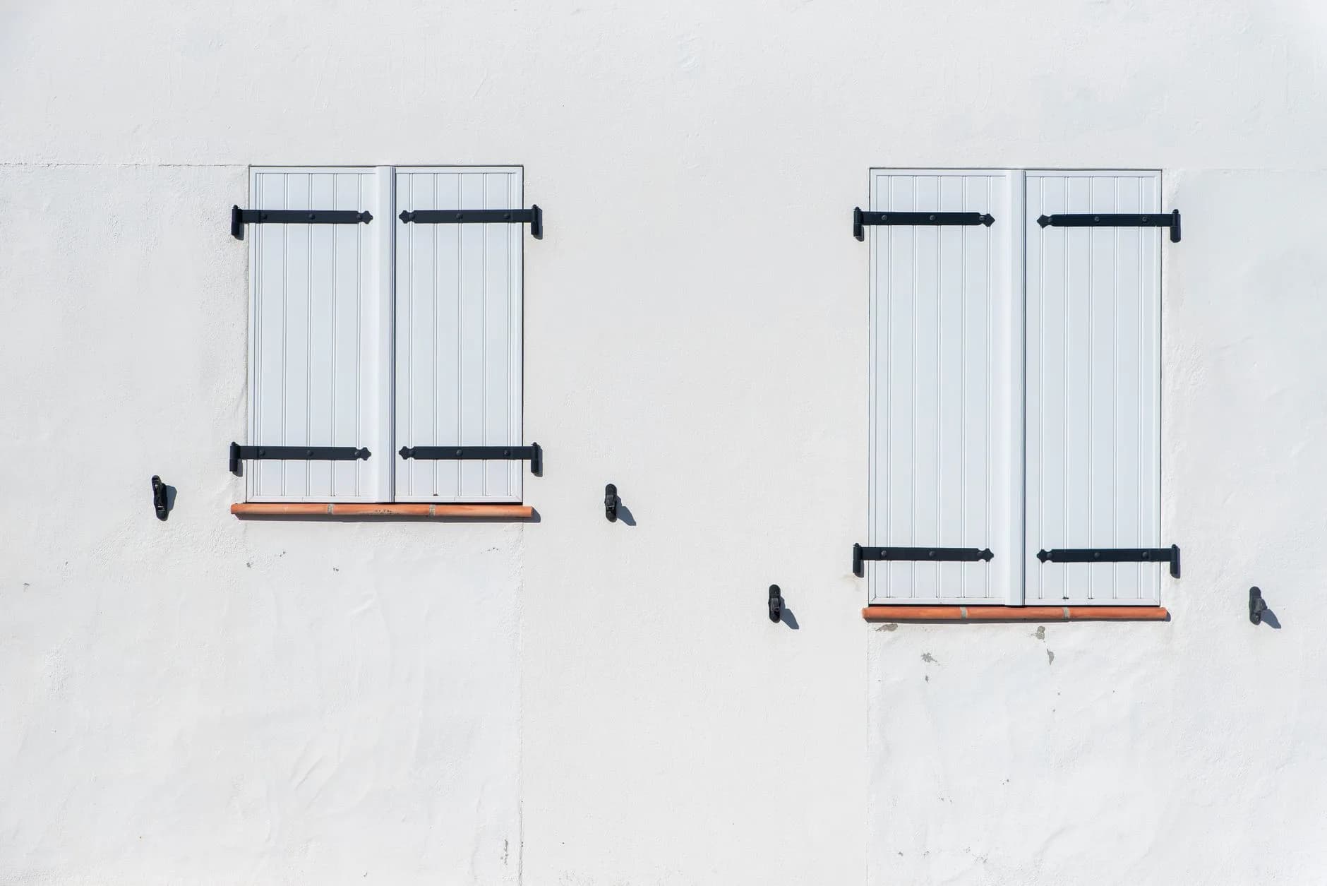 Shutters beside windows