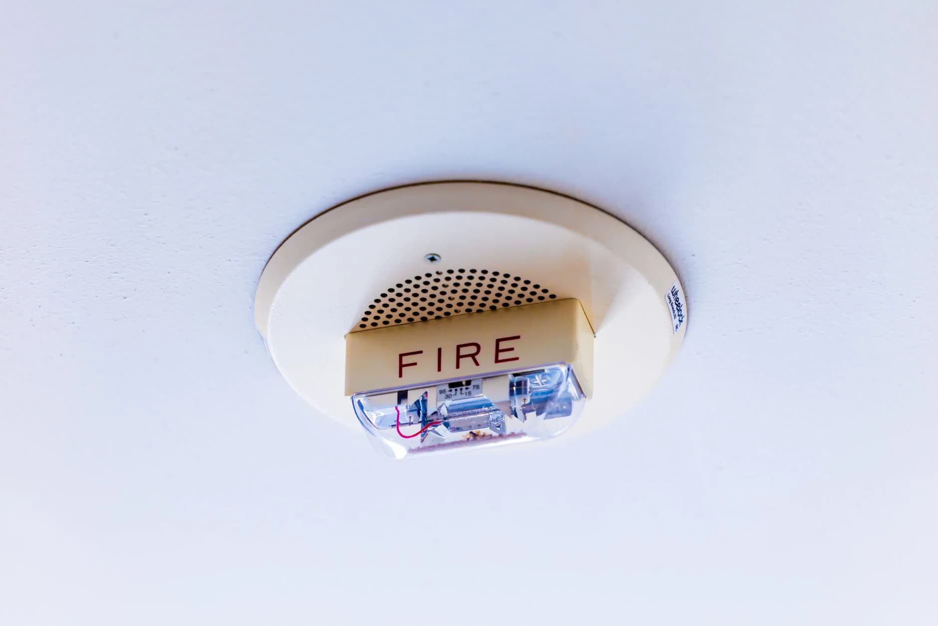 A smoke alarm on a ceiling