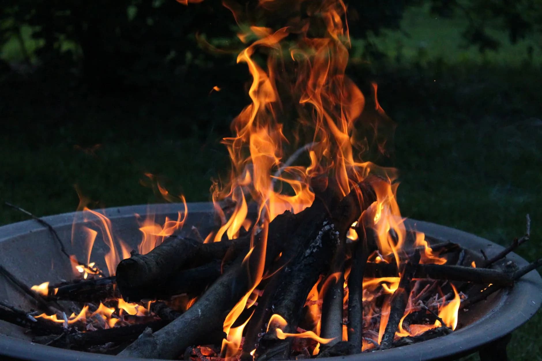 A fire pit burning in a garden