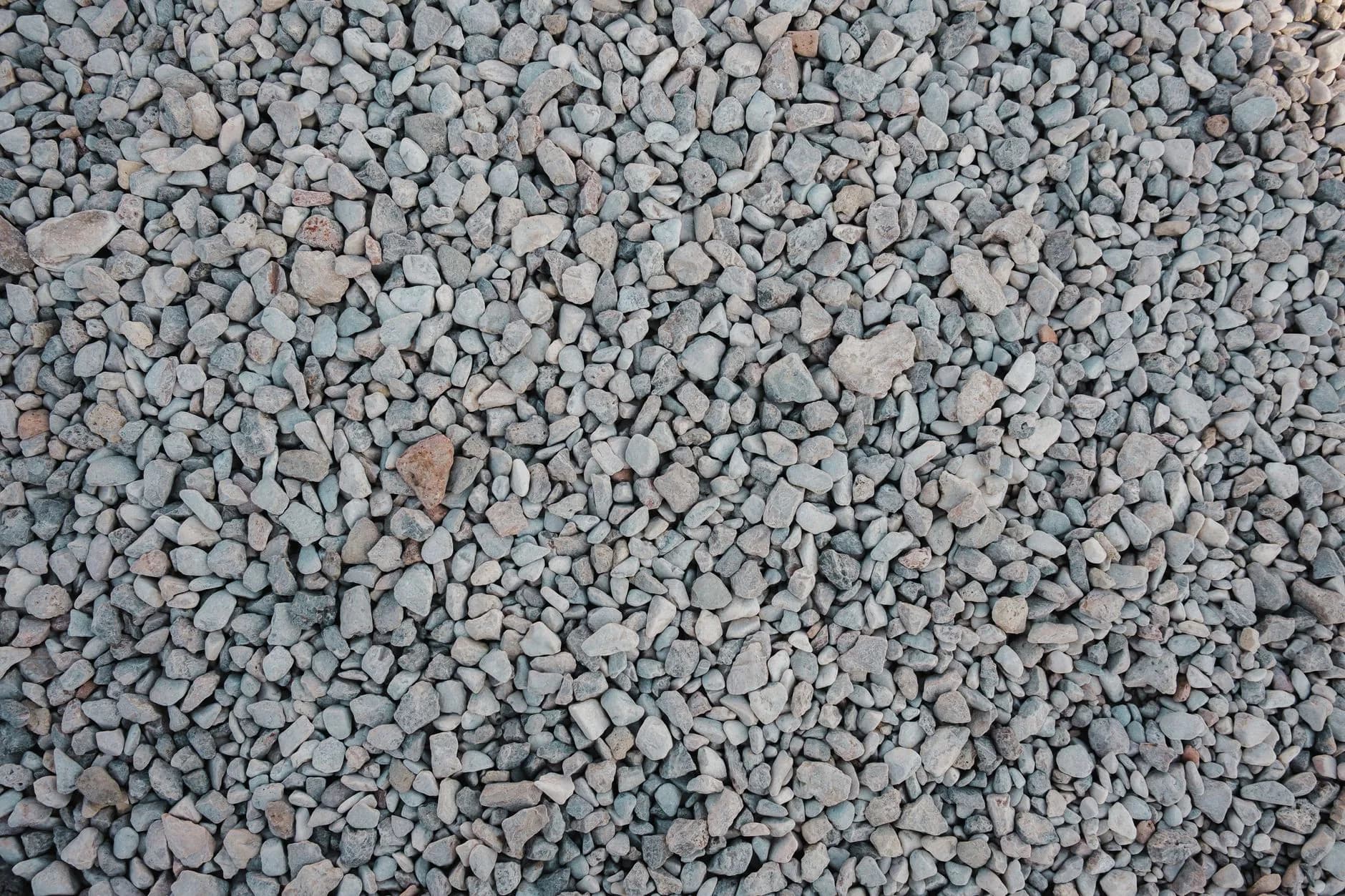 Crushed stone being compacted with a plate compactor