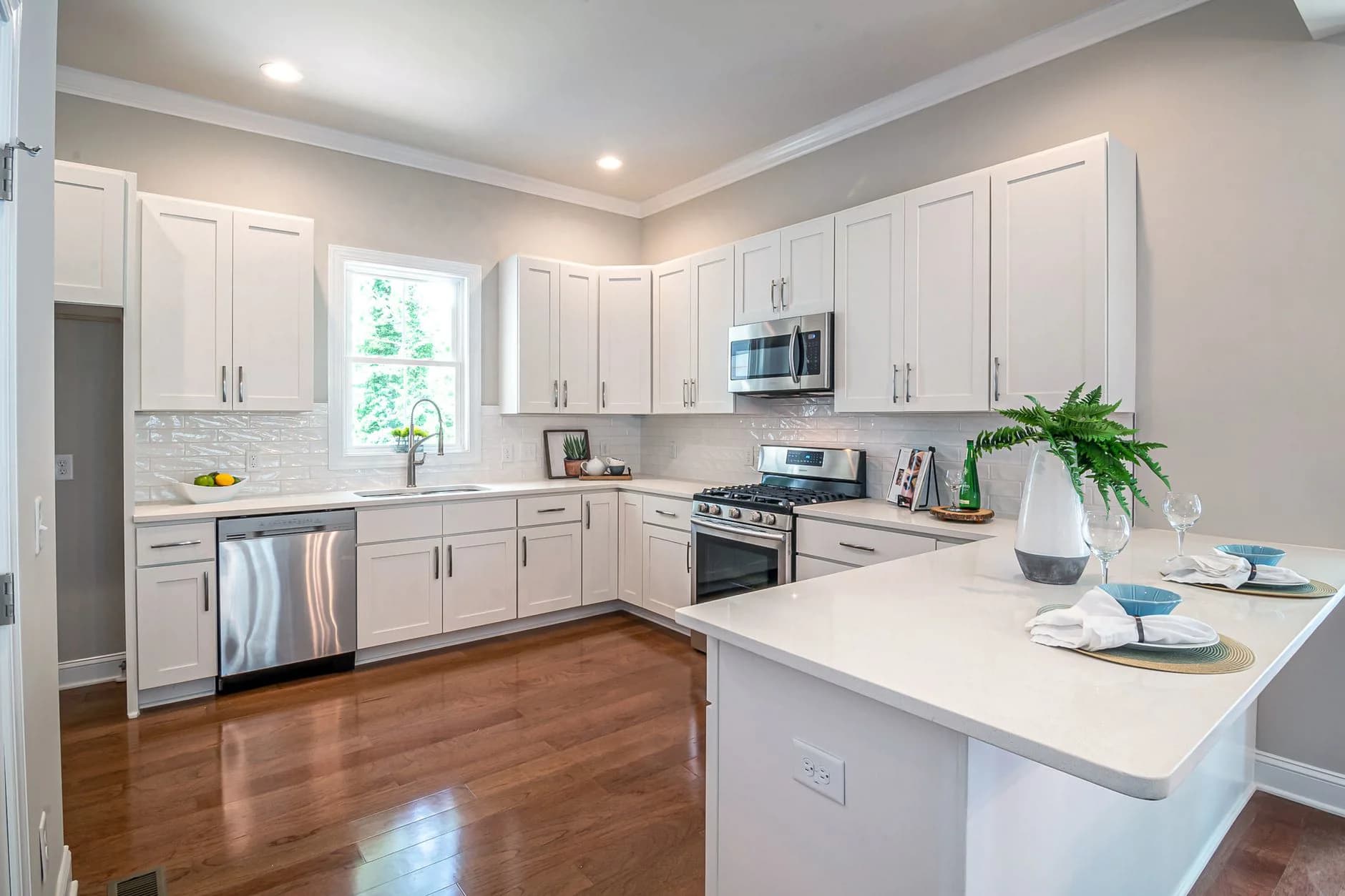 A kitchen countertop with a microwave plugged into a wall outlet
