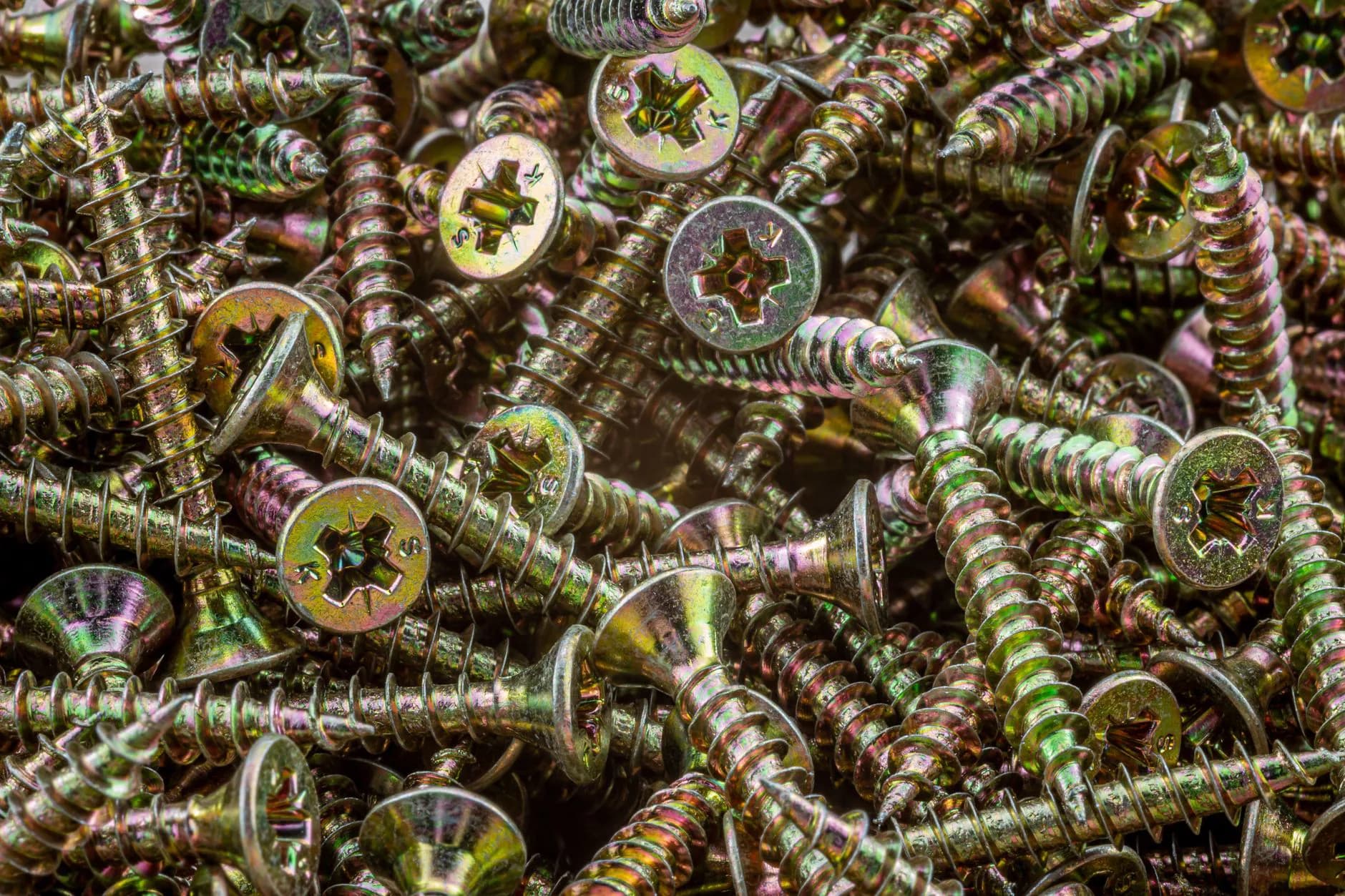 Steel helical pile shafts with welded helix plates laid out on a job site