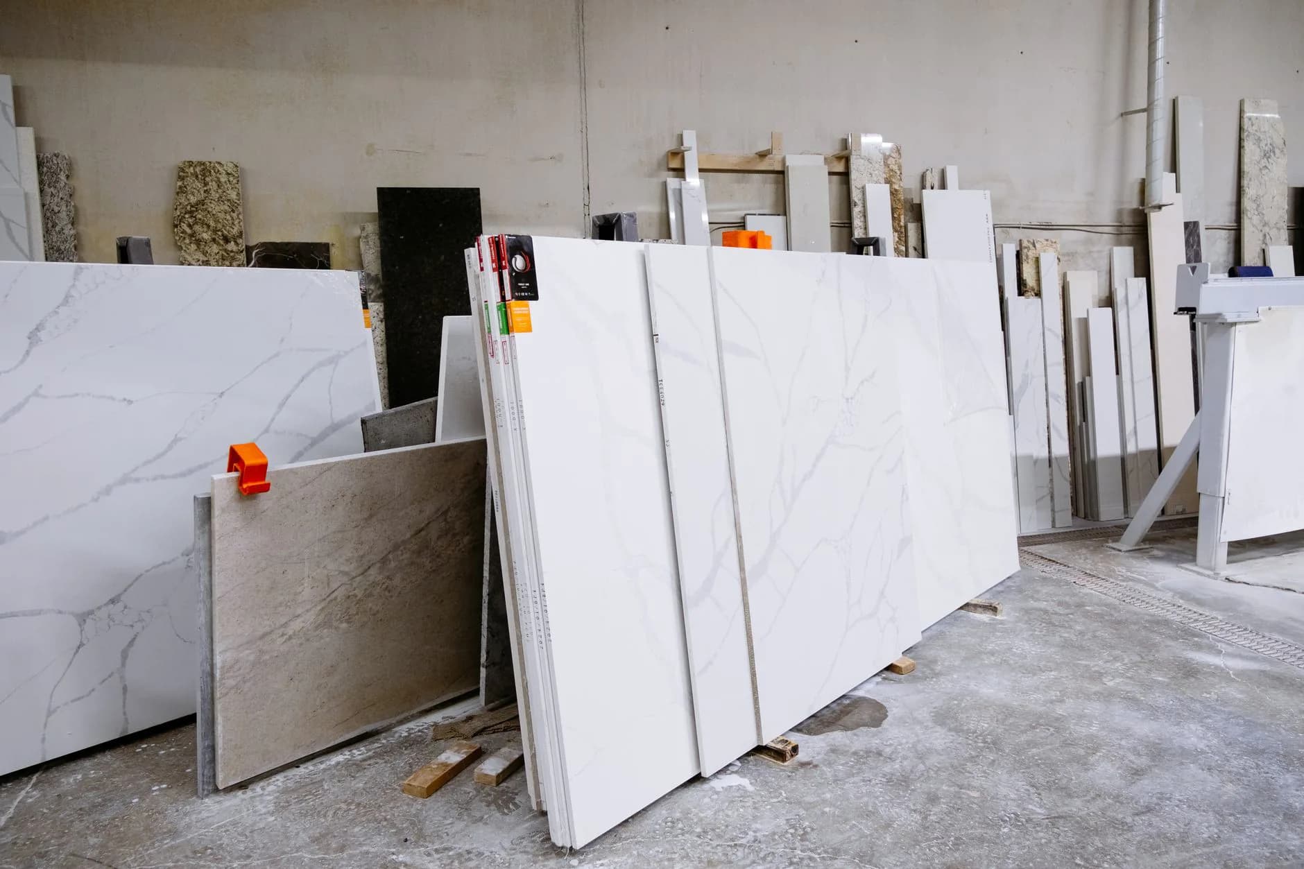 Large granite slabs standing upright in racks at a stone yard