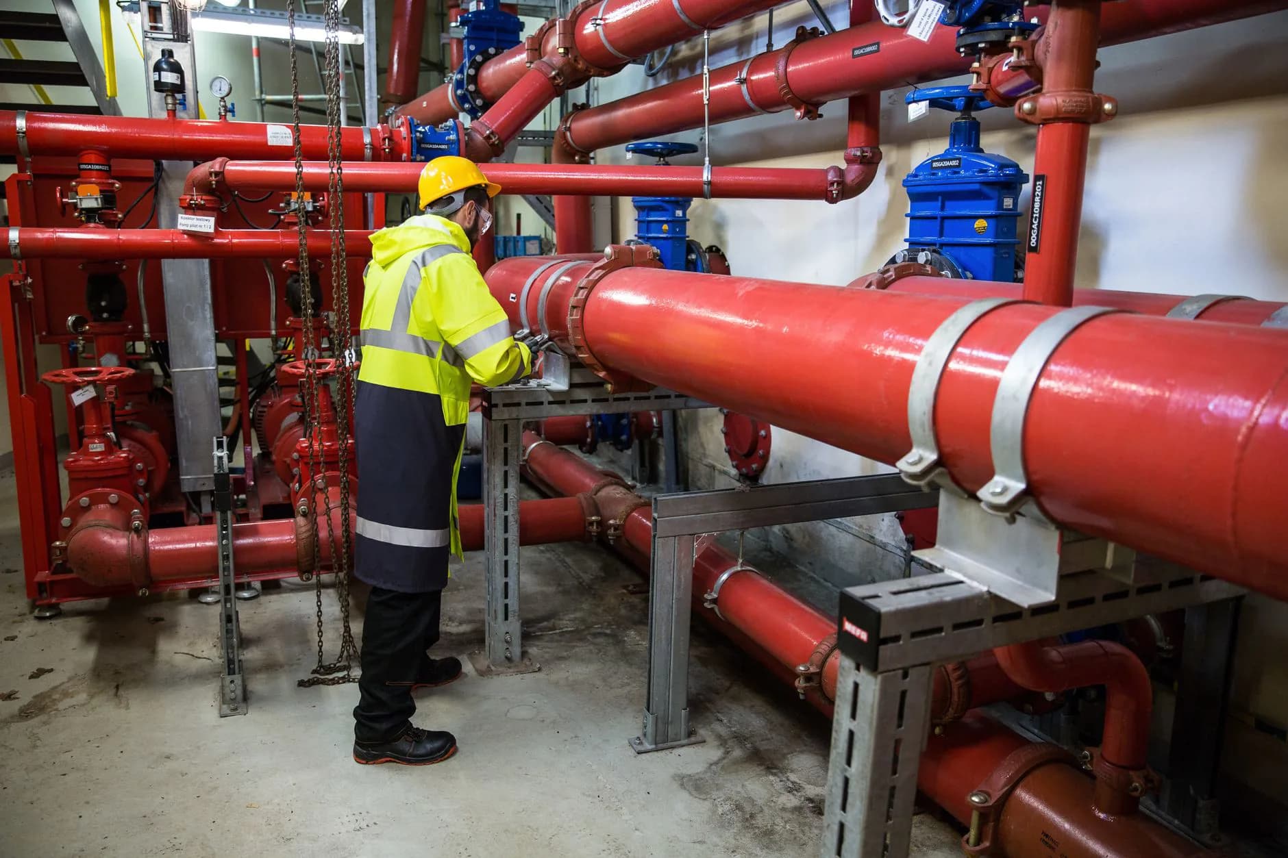 A plumber watching a monitor while a camera on a cable is pushed into a drain